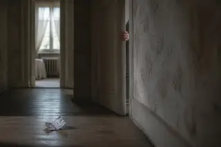 Half-open door in a dim corridor, blurred shadow of a person passing, golden dusk light and peeling wallpaper create a quiet, suggestive mood.